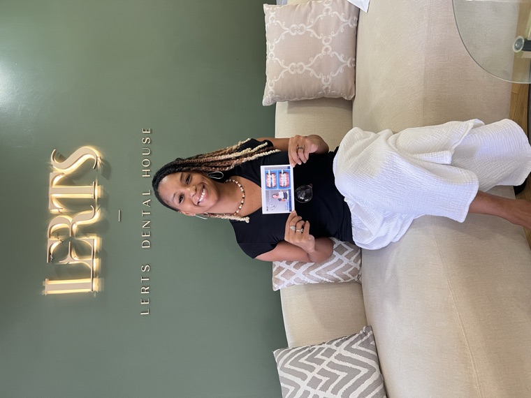 Patient holding her before-and-after smile card at Dental Excellence by LERTs, Chiang Mai