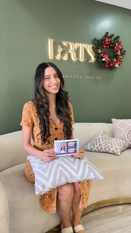 Patient holding her before-and-after smile card at the LERTS Dental House studio, Chiang Mai