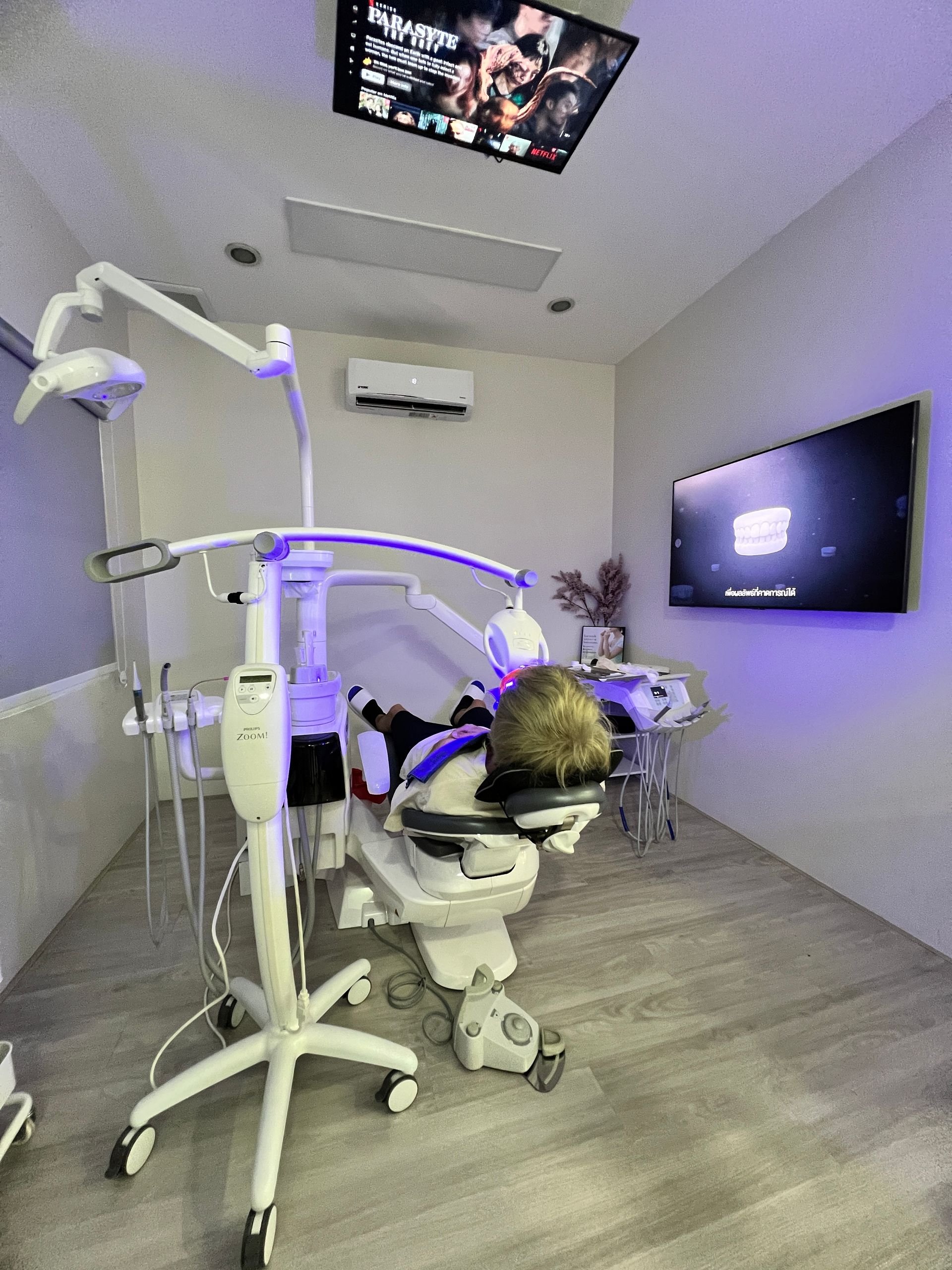 Whitening suite with Parasite playing on the ceiling screen